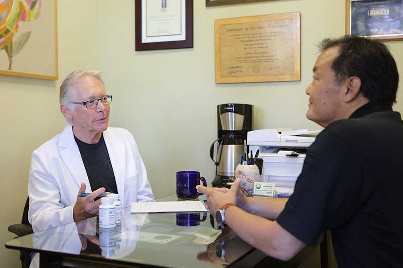 Jeff Barris consulting with a patient